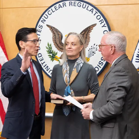 Commissioner Ho Nieh, left, is administered the oath of office by former Commissioner William Ostendorf, right, during a swearing-in ceremony at the U.S. Nuclear Regulatory Commission headquarters in Rockville, Md.